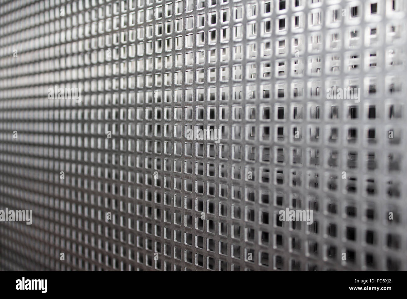 Perforated metal plate iron steel sheets with gridded wholes pattern for industrial processing Stock Photo
