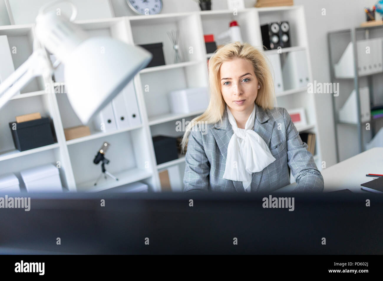Young girl in office working with computer and documents Stock Photo ...