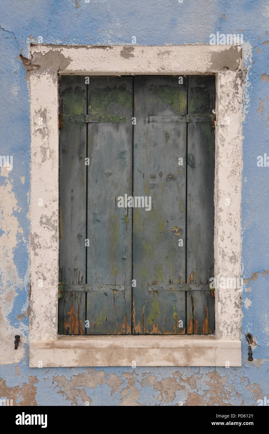 Old closed window with shutter on blue wall Stock Photo - Alamy