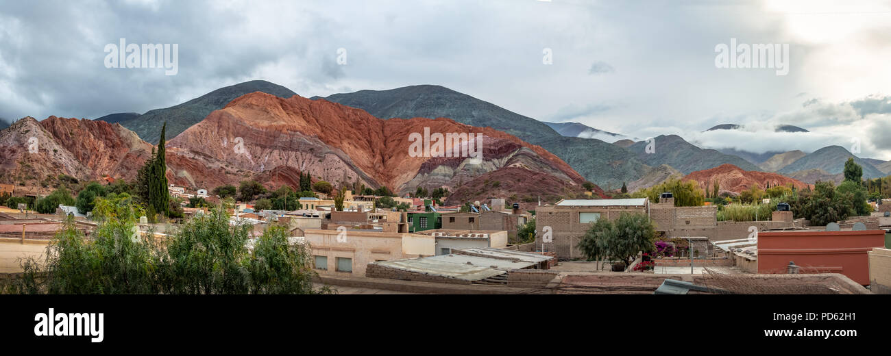 Panoramic view of Purmamarca town with the Hill of Seven Colors (Cerro de los siete colores) on background  - Purmamarca, Jujuy, Argentina Stock Photo