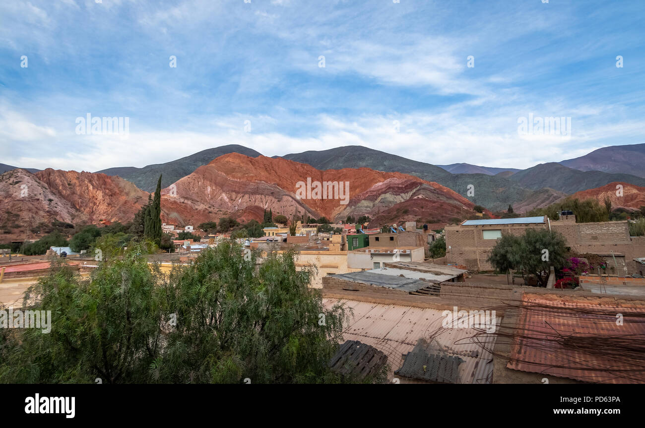 Panoramic view of Purmamarca town with the Hill of Seven Colors (Cerro de los siete colores) on background  - Purmamarca, Jujuy, Argentina Stock Photo
