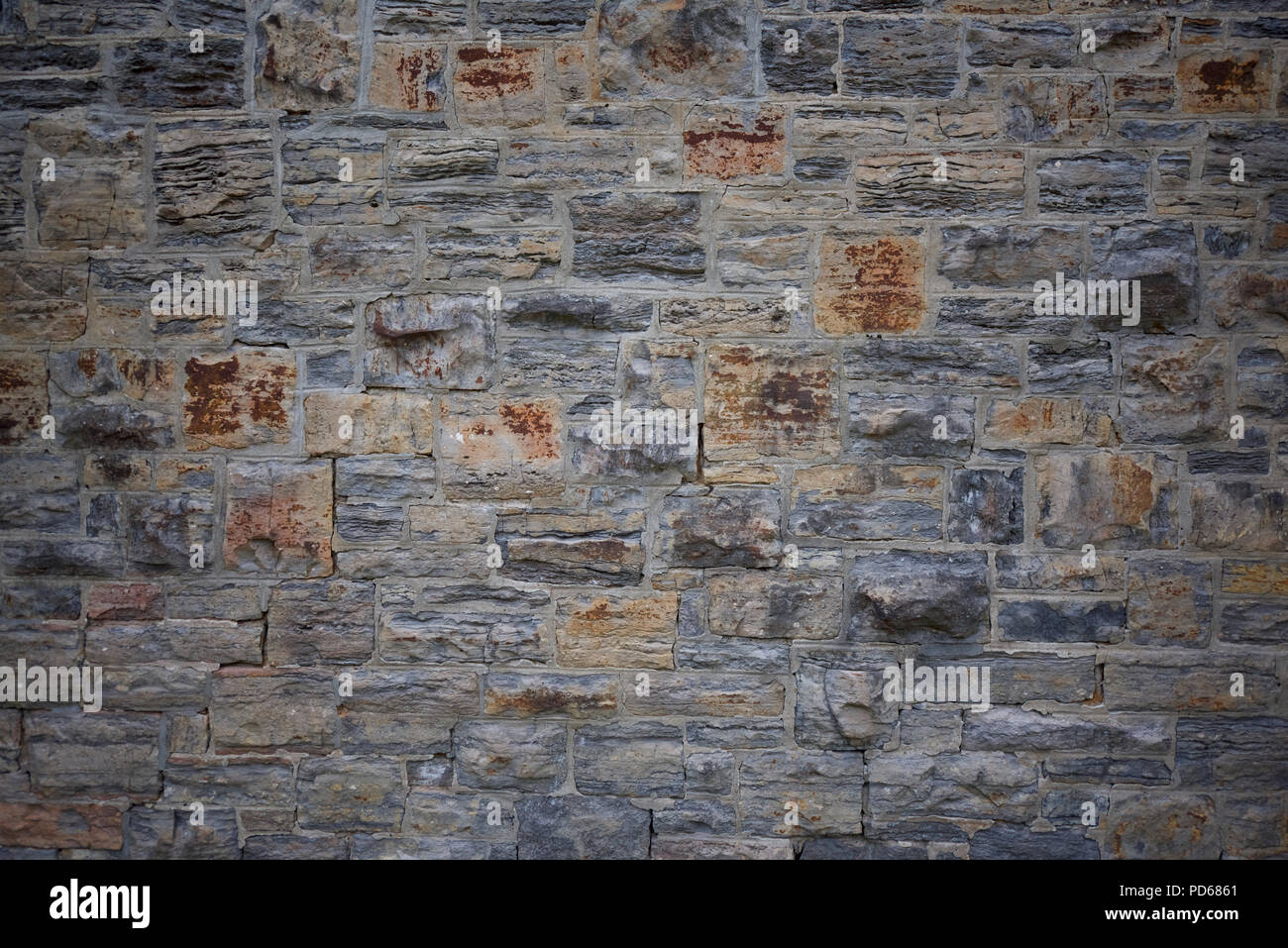 Old stone wall in Montreal with fracturing mortaring. Stock Photo