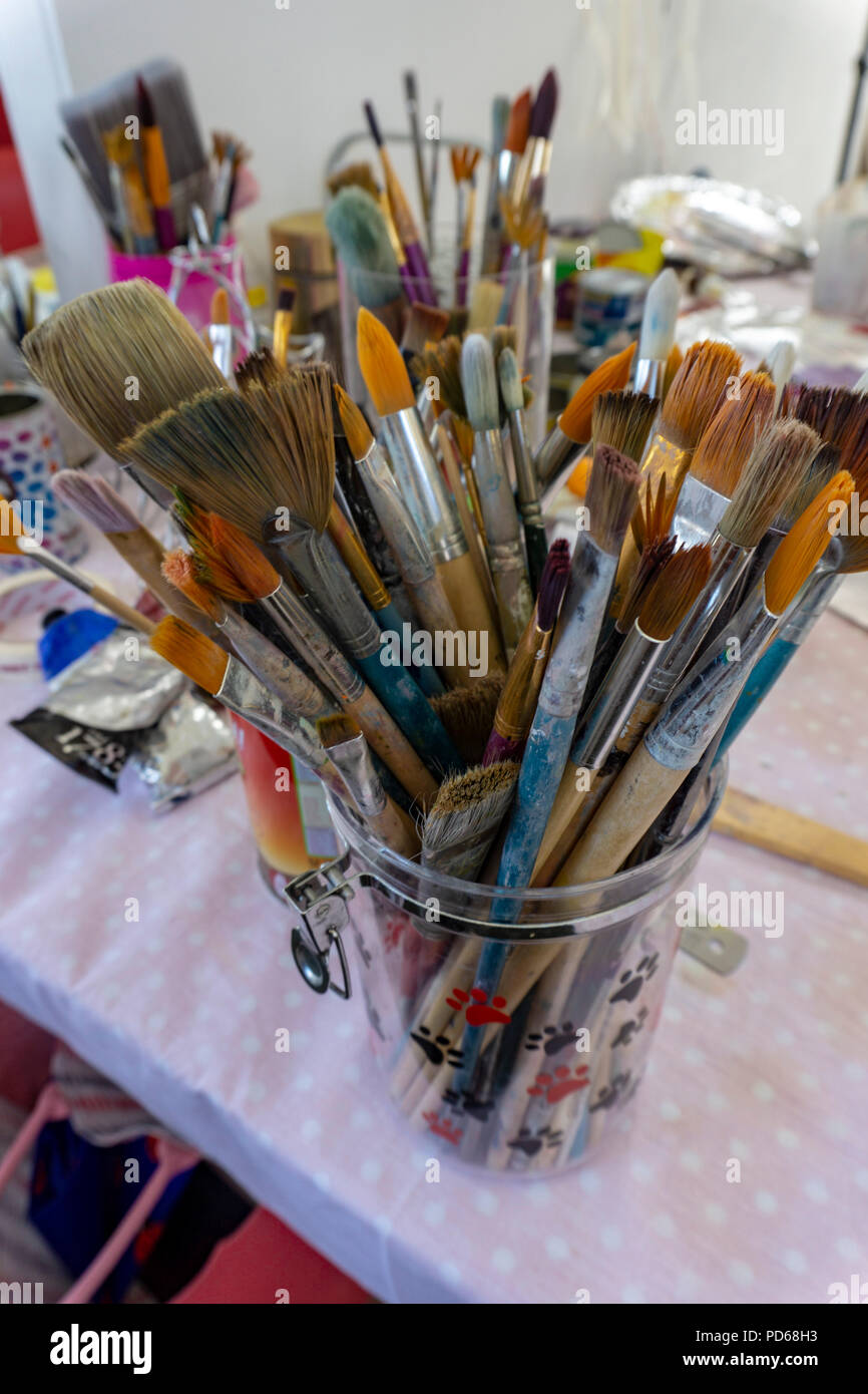 Paint brushes and art supplies in an art studio. Stock Photo
