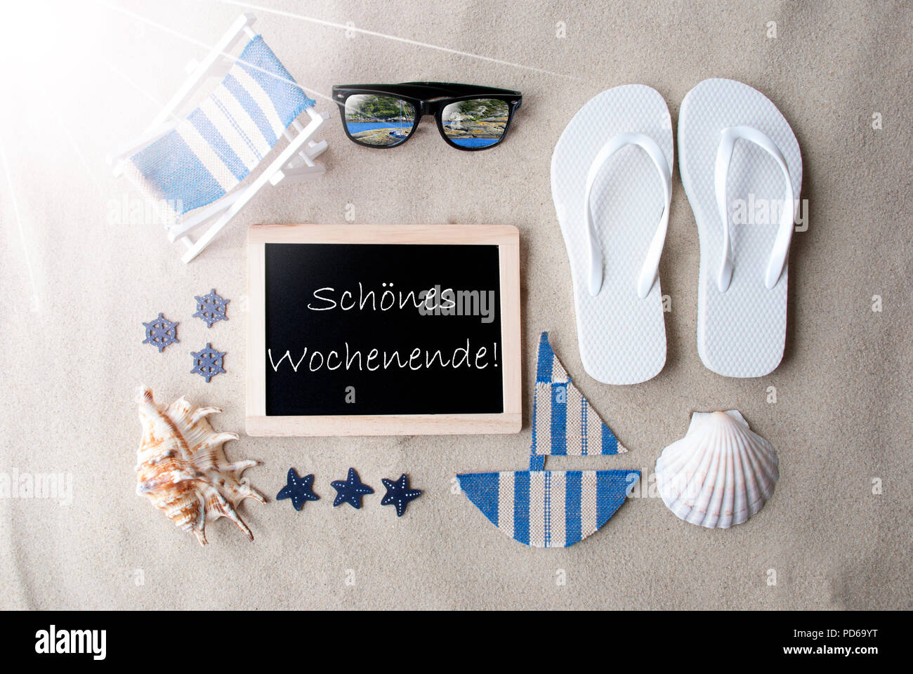 Sunny Blackboard On Sand, Schoenes Wochenende Means Happy Weekend Stock Photo
