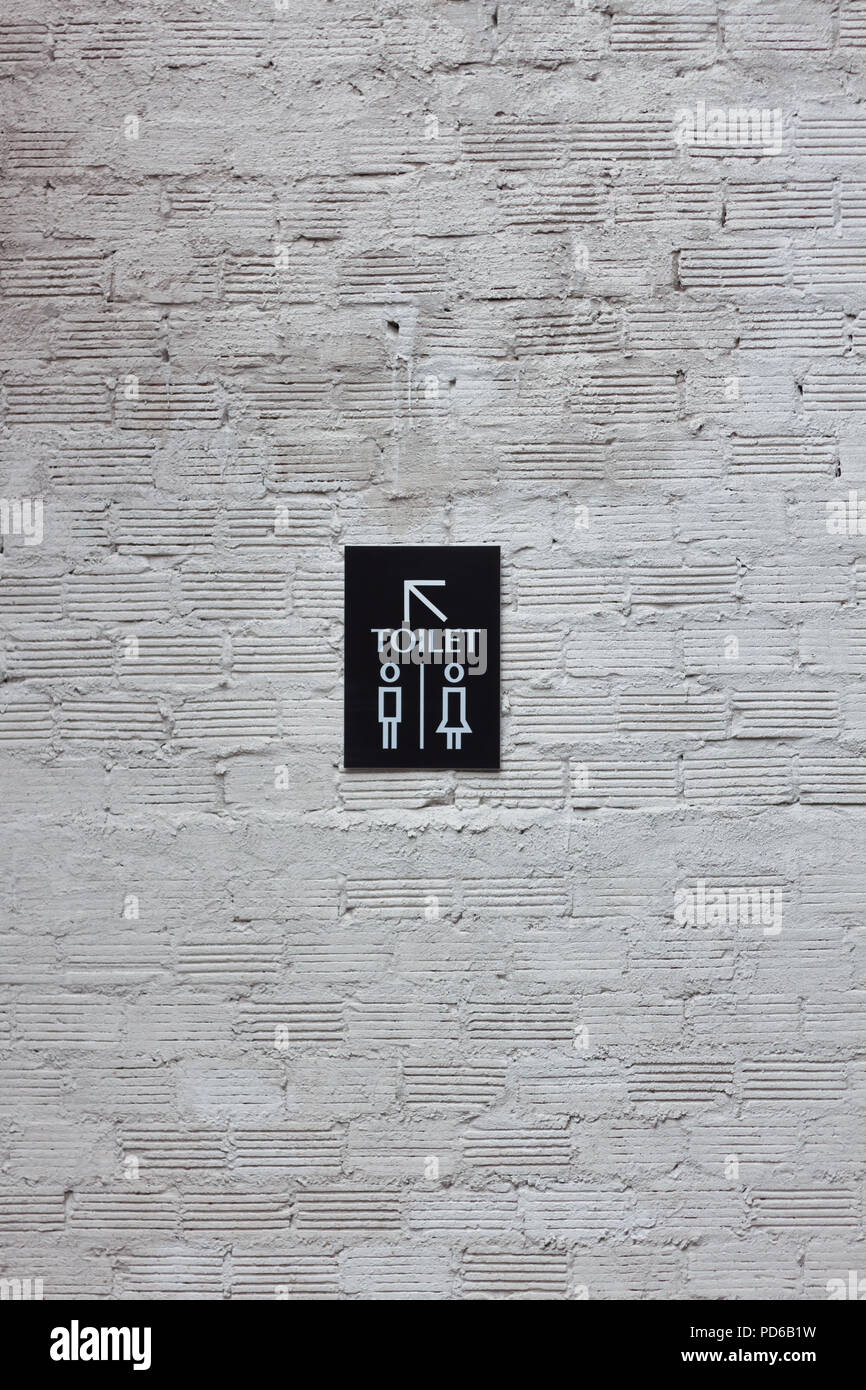 Toilet signs on white wall background, stock photo Stock Photo - Alamy