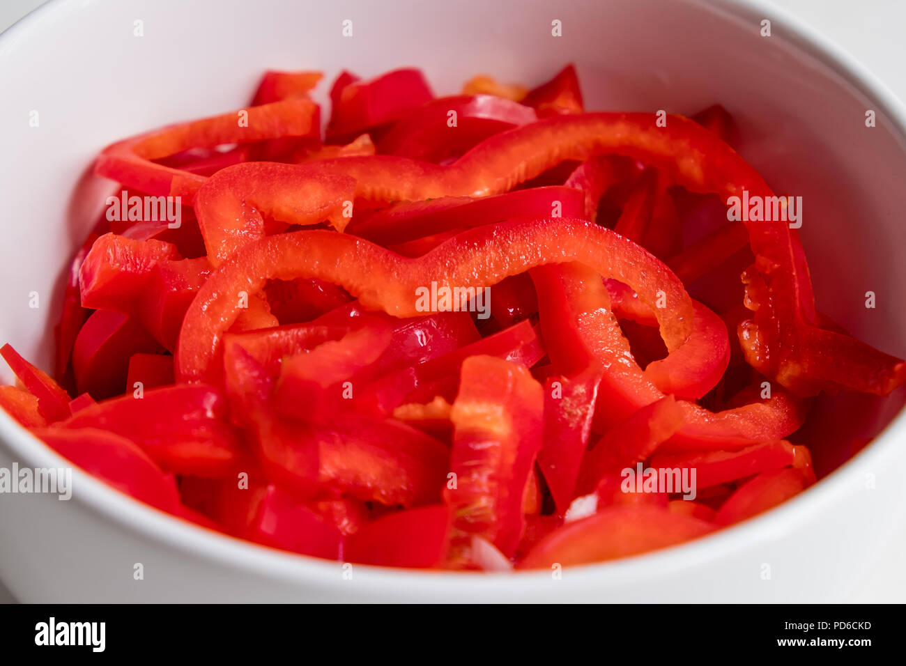 top view of sliced red bell pepper on white counter top Stock Photo - Alamy