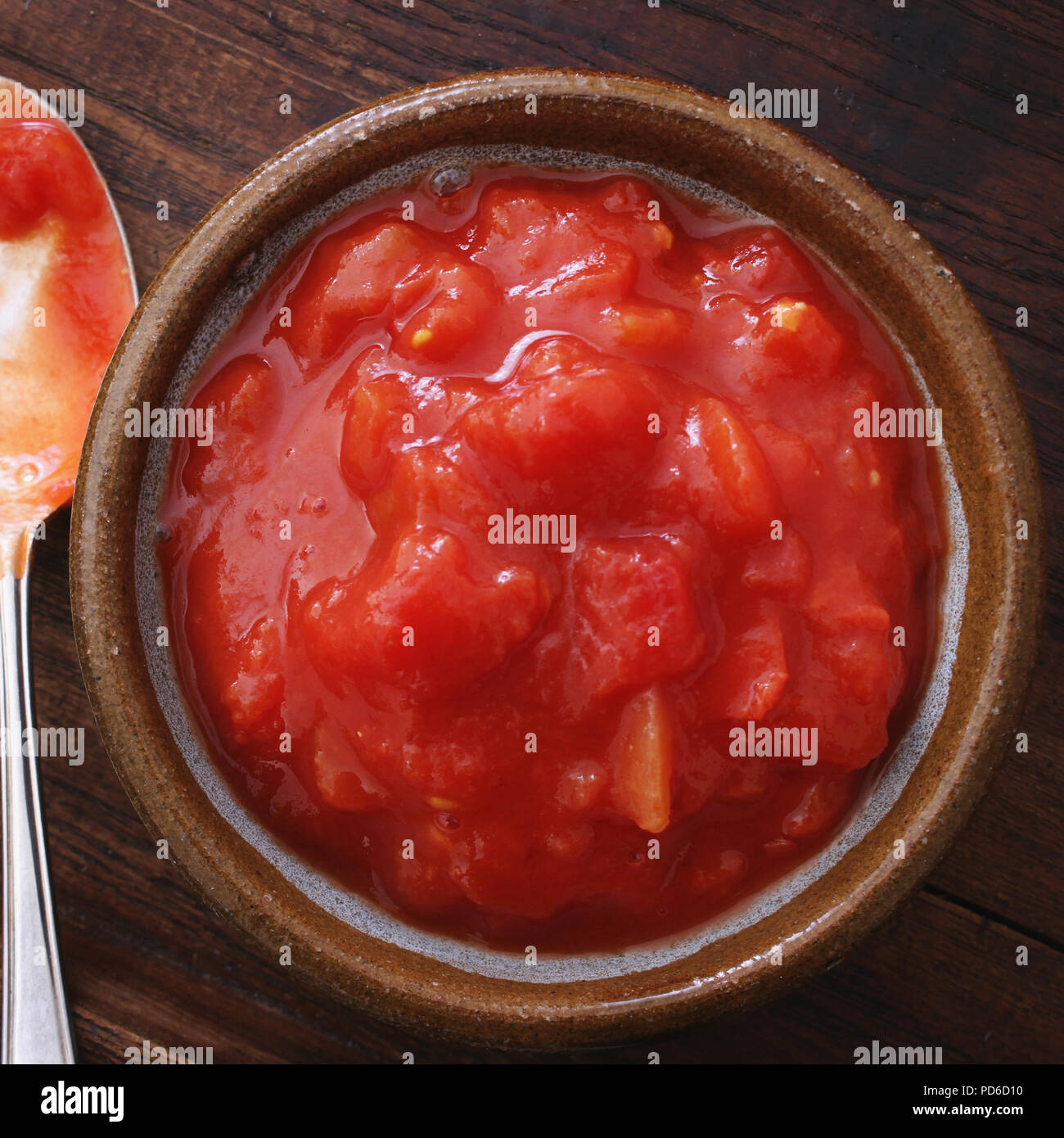 chopped timnned tomatoes in dish Stock Photo Alamy