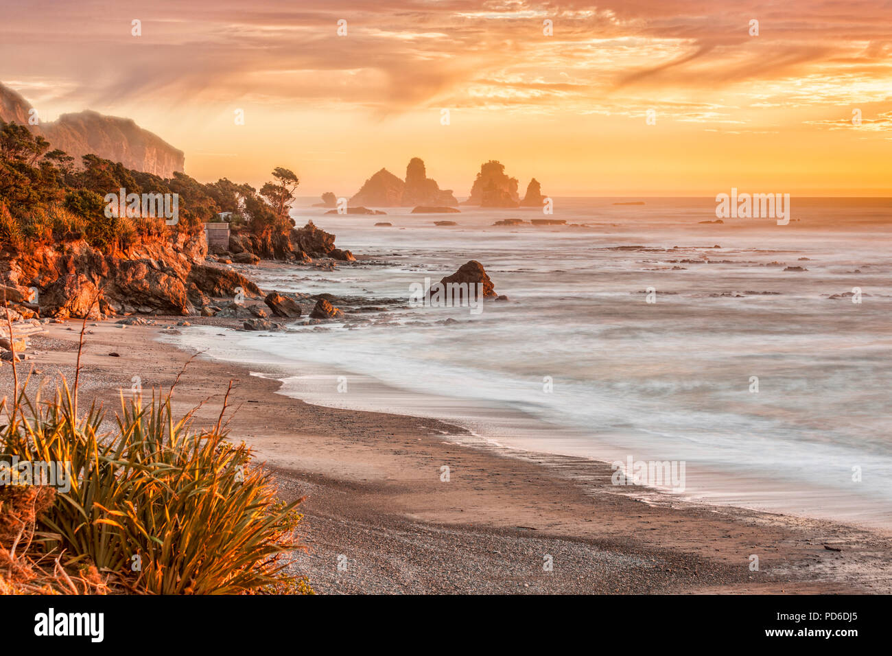 Sunset at one of New Zealand's most dramtic bits of scenery, Motukiekie, on the West Coast of the South Island. Focus on centre. Stock Photo