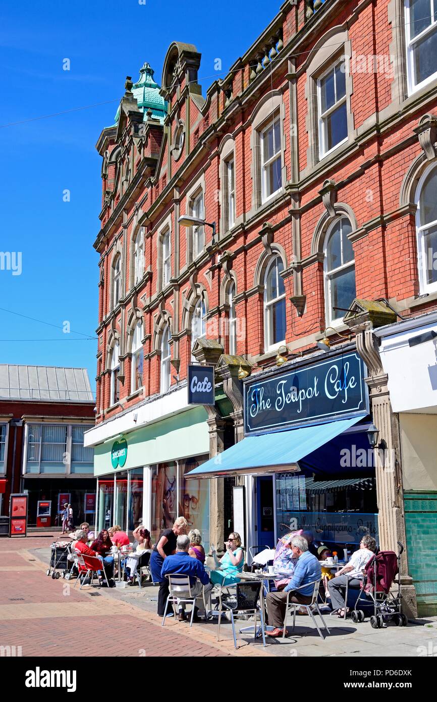 People relaxing outside The Teapot Cafe in the Market Place, Burton upon Trent, Staffordshire, England, UK, Western Europe. Stock Photo