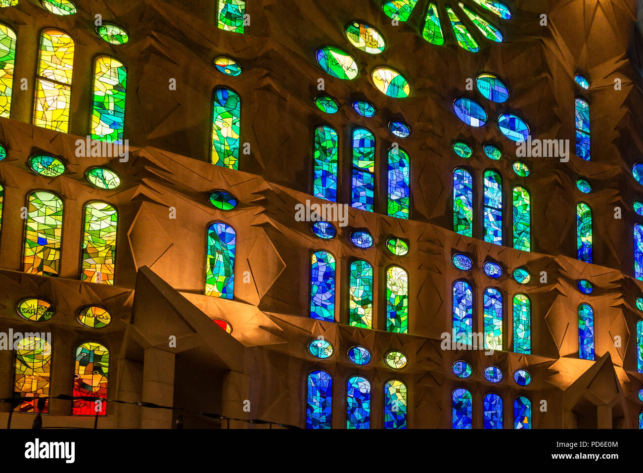 Colorful stained glass window of the Sagrada Familia - large unfinished Roman Catholic church in Barcelona, designed by Catalan architect Antoni Gaudi Stock Photo