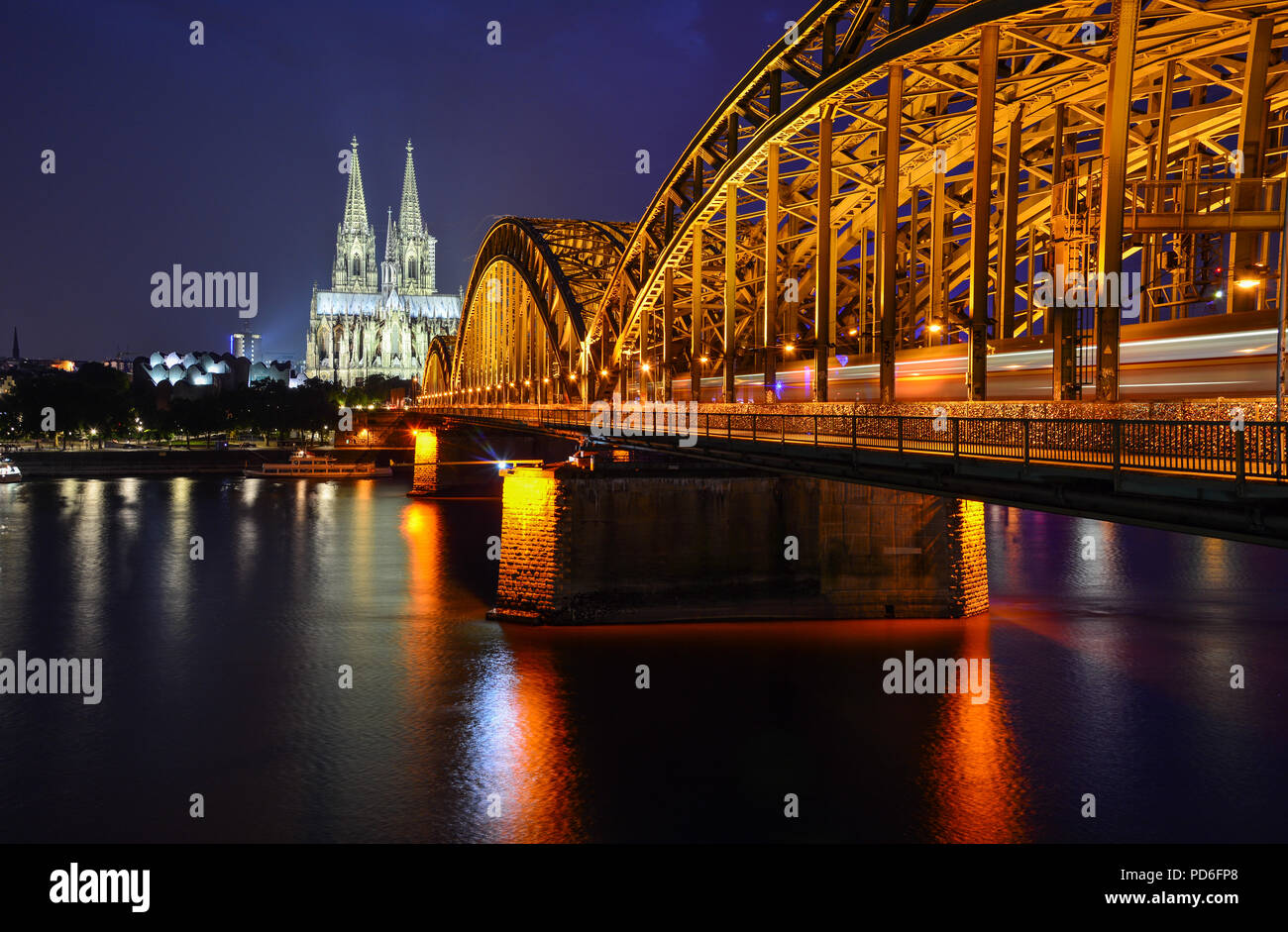 Night panorama of Cologne, Germany, with the river Rhine, the railway Hohenzollern Bridge and Cologne Cathedral Stock Photo