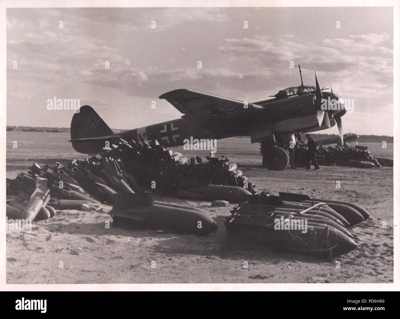 Image from the photo album of Oberleutnant Oscar Müller of  Kampfgeschwader 1: Junkers Ju88A-4 V4+AN of 5./KG 1 sits armed and loaded on a Russian airfield, ready for its next mission. Additional bombs are placed nearby for speedy re-arming. Stock Photo
