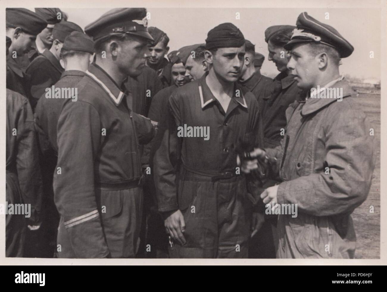 Image from the photo album of Oberleutnant Oscar Müller of  Kampfgeschwader 1: A Luftwaffe officer talks to members of the ground crew of 5. Staffel Kampfgescwader 1 'Hindenburg' at Dno Airfield in Russia, 1942. Stock Photo