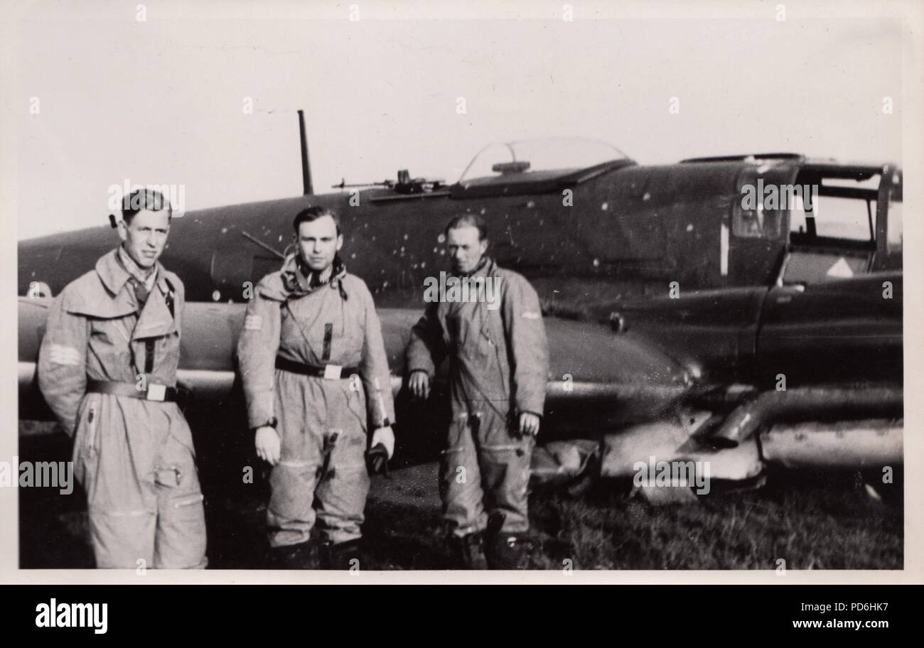 Image from the photo album of Oberleutnant Oscar Müller of  Kampfgeschwader 1: The NCO crew members stand beside Heinkel He 111 H-2 (Wrk Nr. 2728) V4+CV of 5./KG 1 at Harchies in Belgium after it was force-landed by Leutnant Oscar Müller on the night of 16th/17th October 1940 as a result of Flak damage received during a sortie over London during the Battle of Britain. The crew  of  Leutnant Oscar Müller (Pilot), Feldwebel Küchler (Observer), Feldwebel Henke (Radio Operator), and Unteroffizier Georg Schneiderbanger (Flight Engineer) were all unhurt but the aircraft was written off. Stock Photo