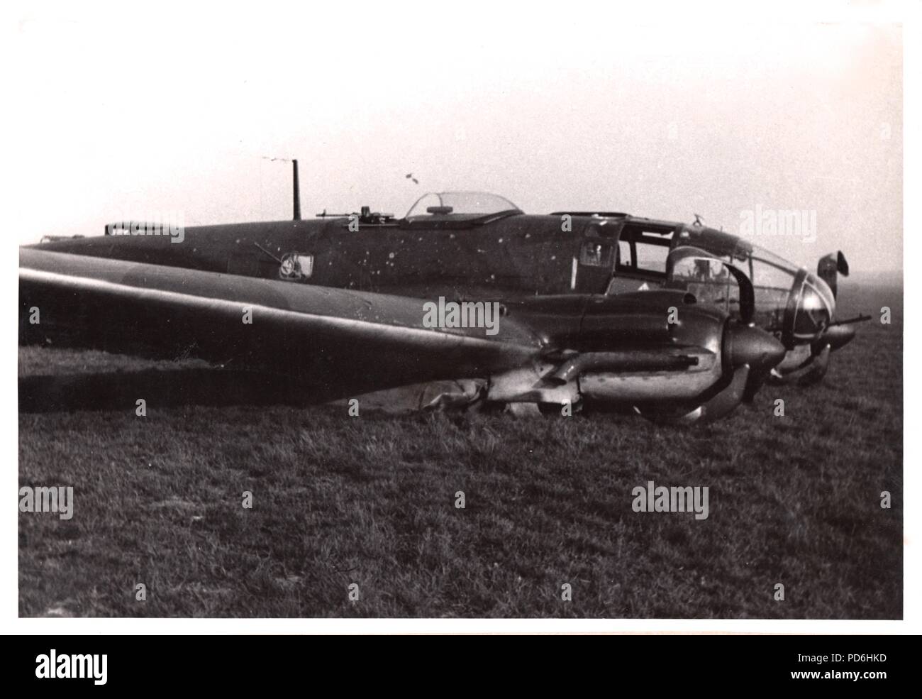 Image from the photo album of Oberleutnant Oscar Müller of  Kampfgeschwader 1: Heinkel He 111 H-2 (Wrk Nr. 2728) V4+CV of 5./KG 1 at Harchies in Belgium after it was force-landed by Leutnant Oscar Müller on the night of 16th/17th October 1940 as a result of Flak damage received during a sortie over London during the Battle of Britain. The crew  of  Leutnant Oscar Müller (Pilot), Feldwebel Küchler (Observer), Feldwebel Henke (Radio Operator), and Unteroffizier Georg Schneiderbanger (Flight Engineer) were all unhurt but the aircraft was written off. Stock Photo