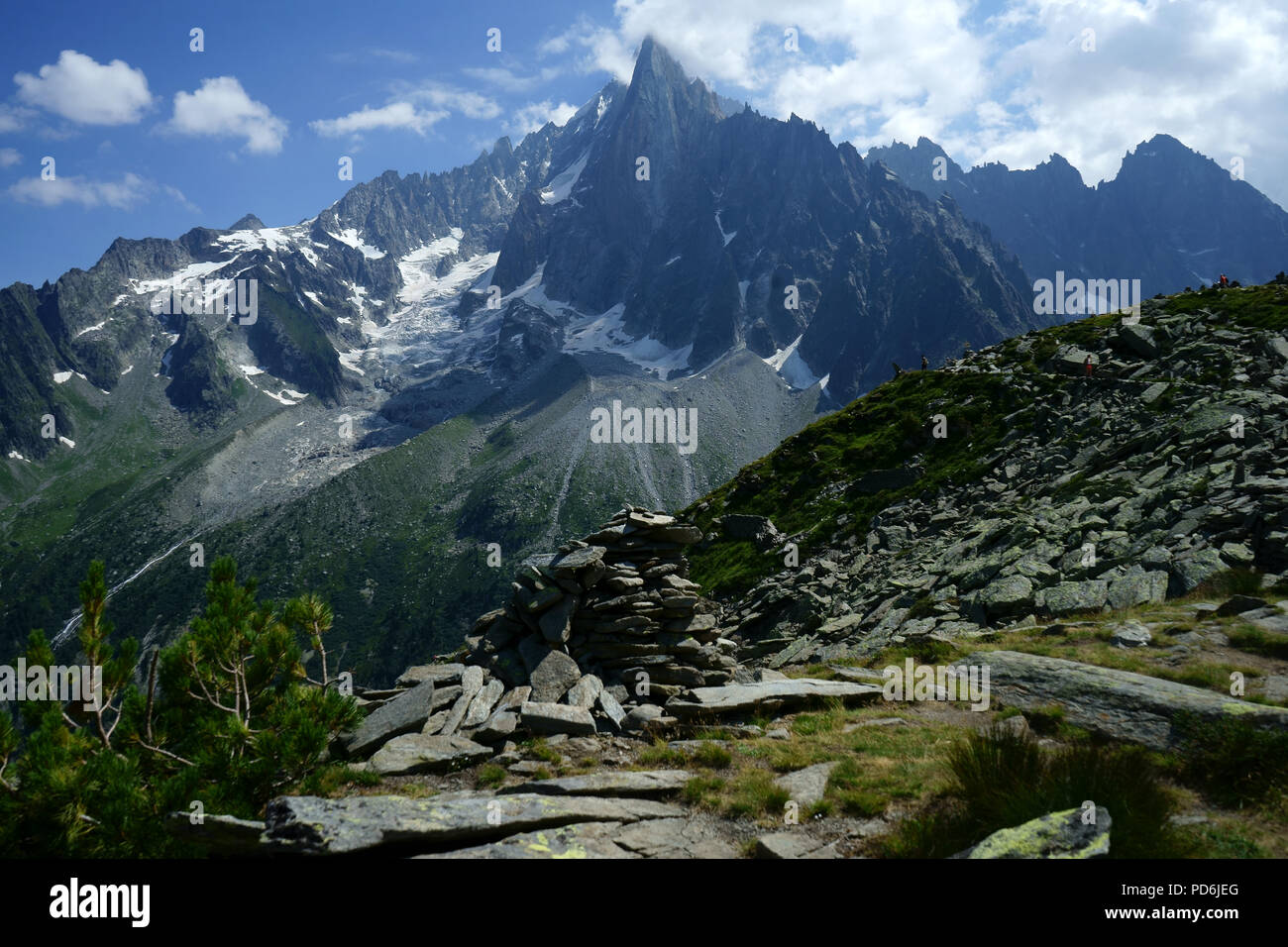 Hiker on trail from Aiguille du Midi to Montanevers in back Les Drus, Mont Blanc mountains,, Chamonis, French alps, Franceloetscher Stock Photo