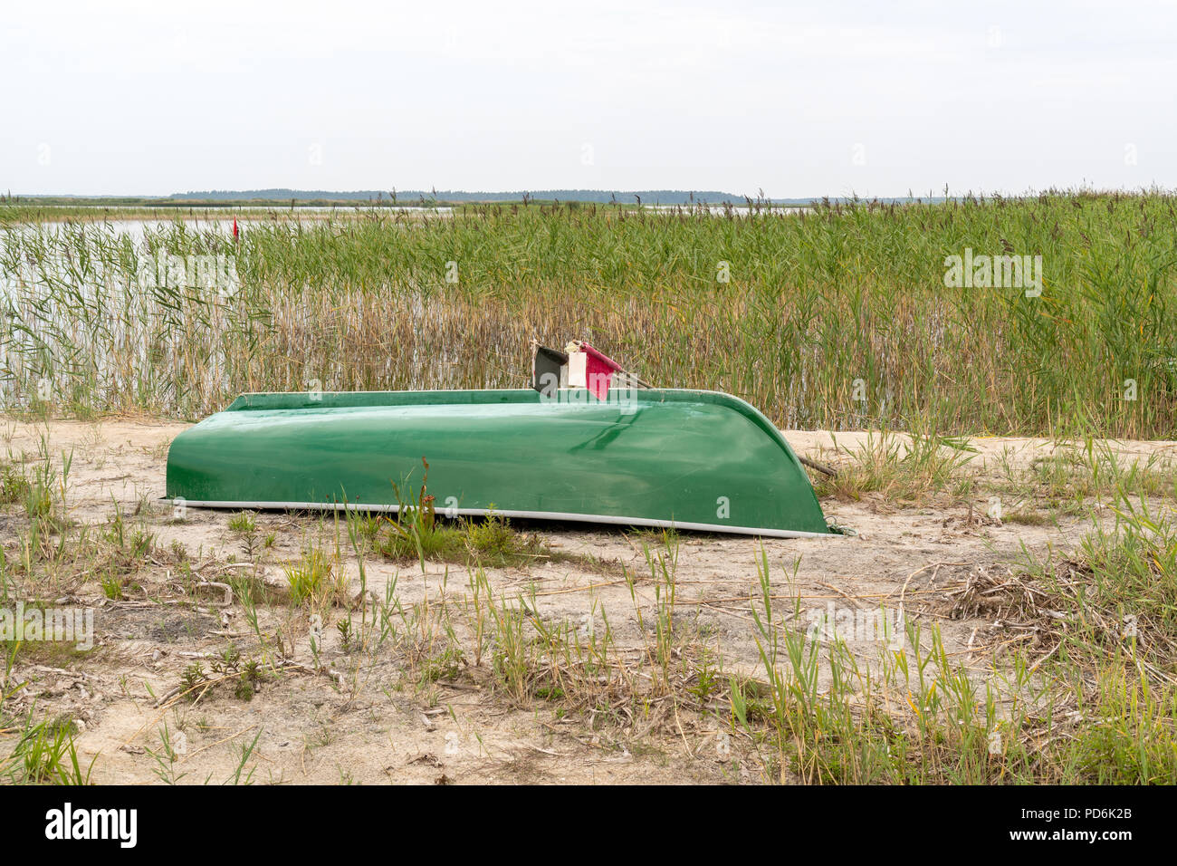 Fishing boat on the beach by the lake turned upside down Stock Photo