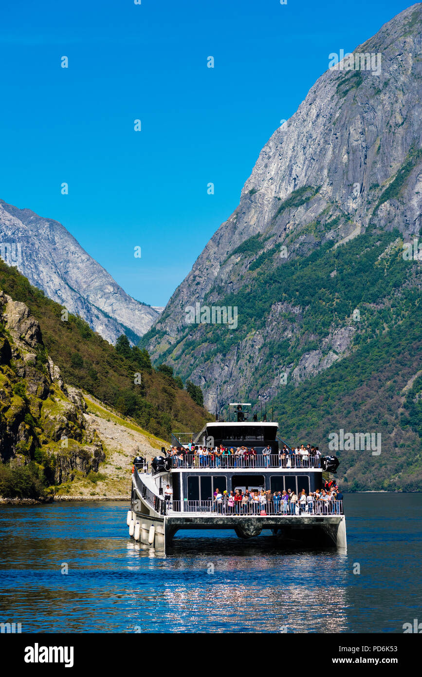 Battery driven passenger boat, first of its kind, in the narrow and famous Norwegian fjord Naeroyfjorden, on the Unesco world heritage list. Stock Photo