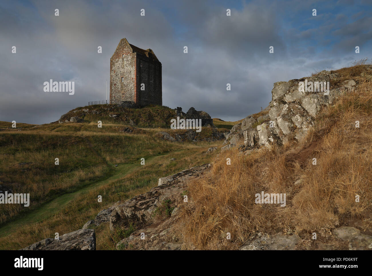 Smailholm Tower is a peel tower that stands around five miles west of Kelso in the Scottish Borders. Its dramatic situation, atop a crag of Lady Hill, Stock Photo