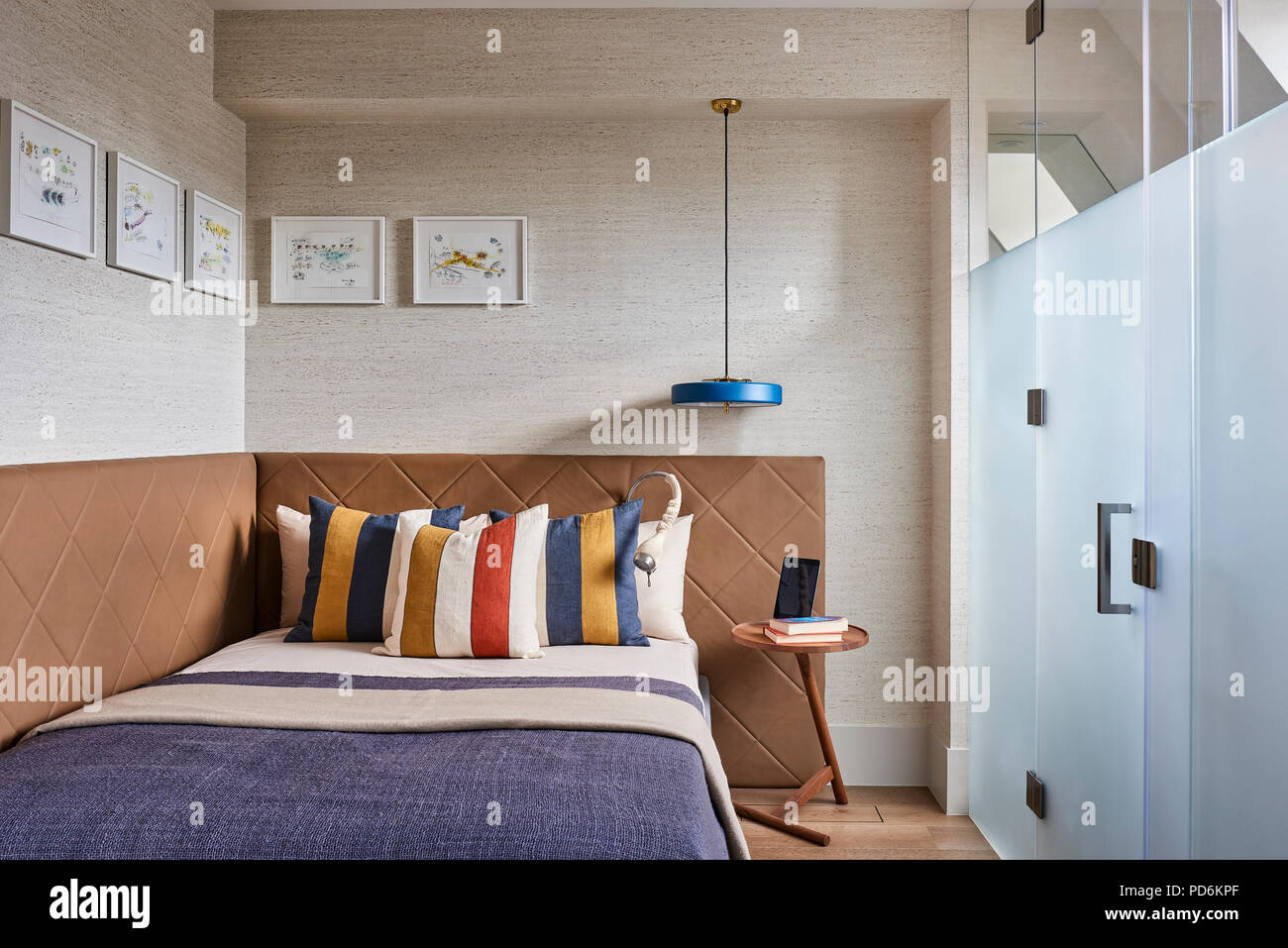 Striped pillows on double bed with frosted glass Stock Photo
