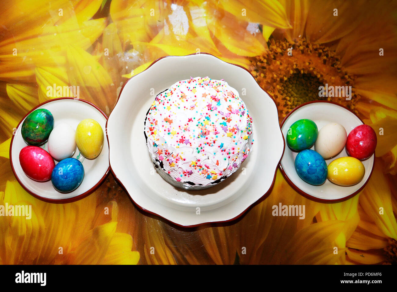 Easter cake with glace icing and easter eggs on table cloth background. Stock Photo