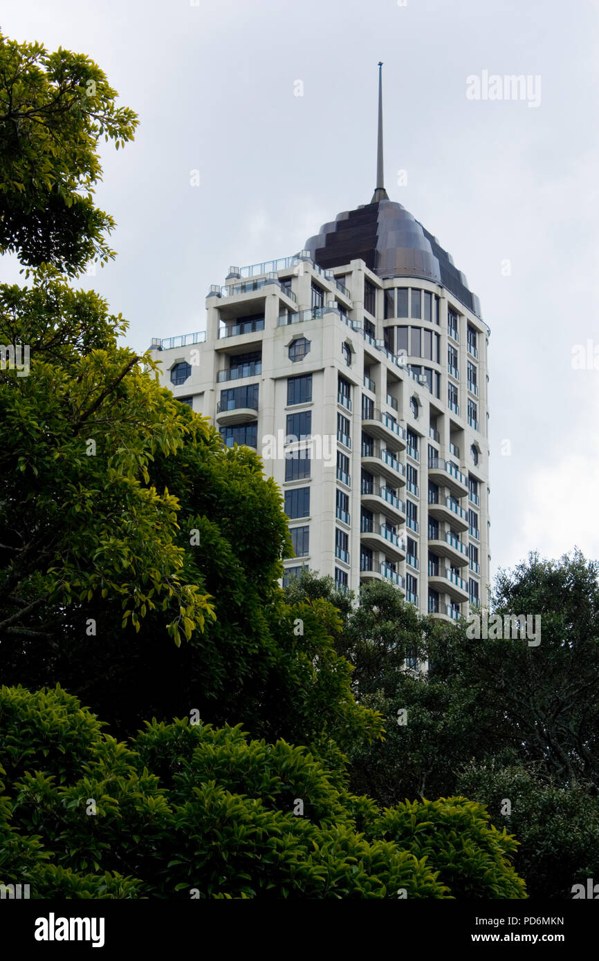 High building behind trees in Albert park Auckland New Zealand Stock Photo