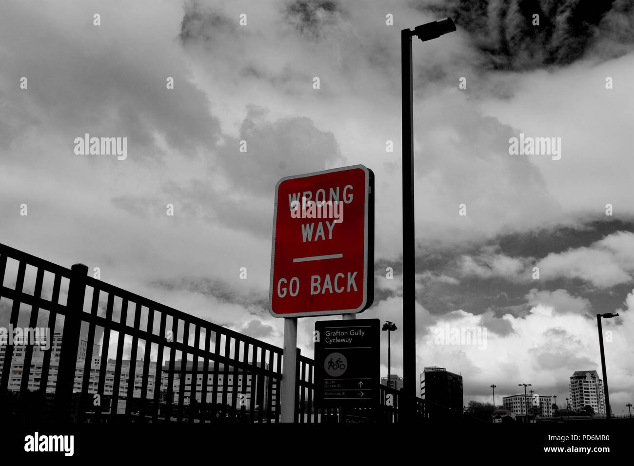 Red road steet sign WRONG WAY GO BACK colorkey black and white in the city of Auckland Stock Photo