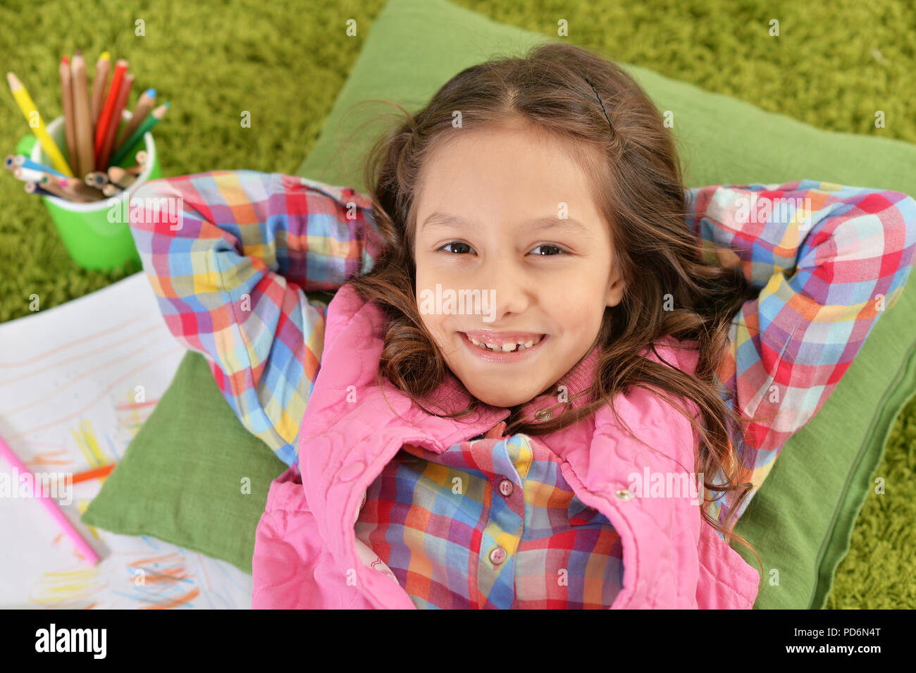 cute smiling girl lying on floor and drawing at home Stock Photo - Alamy
