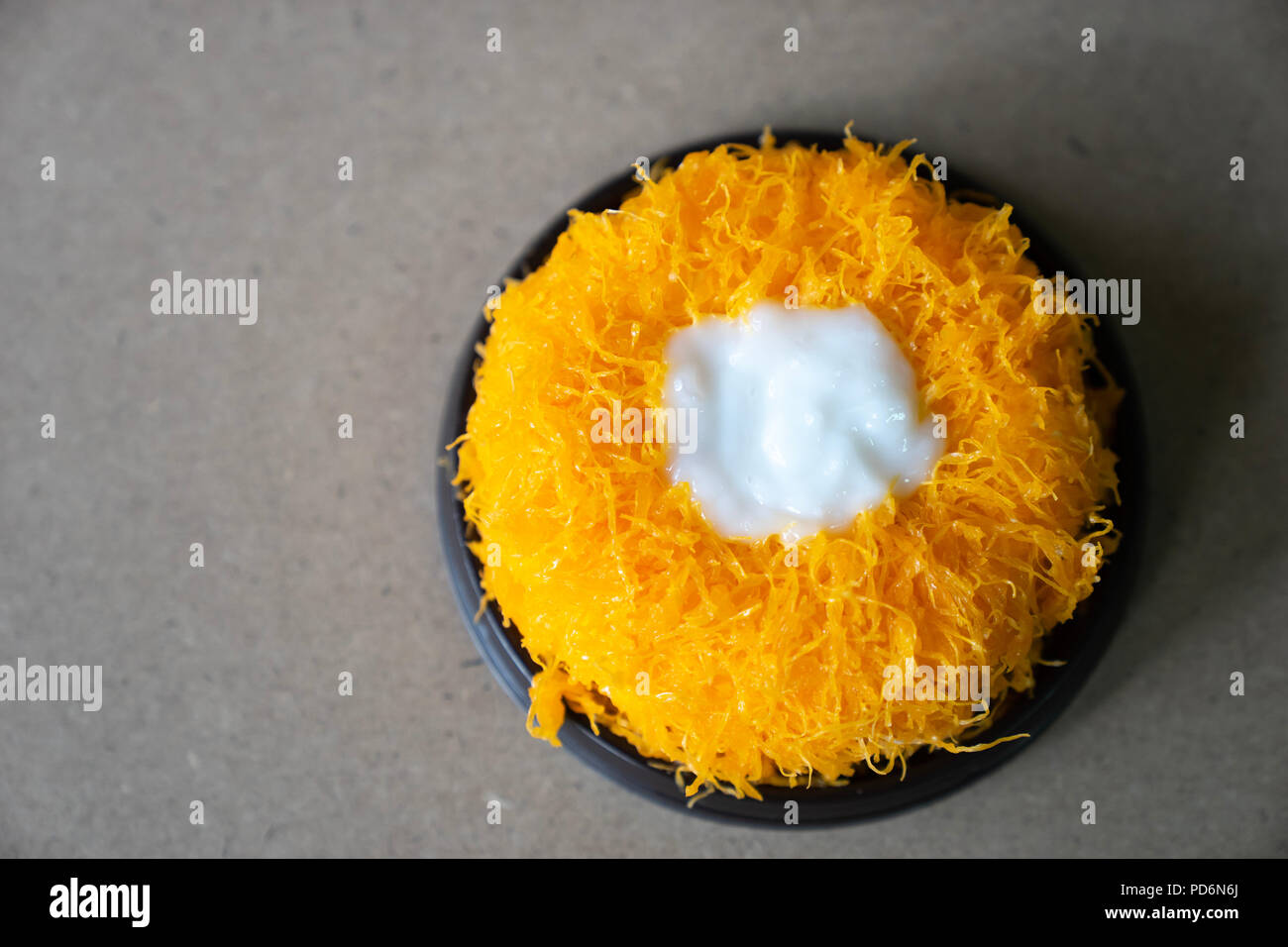 Top view Gold Egg Yolk Thread Cakes, or  'Cake Foi Tong' Thai cake isolated on brown cork table background with copy space Stock Photo