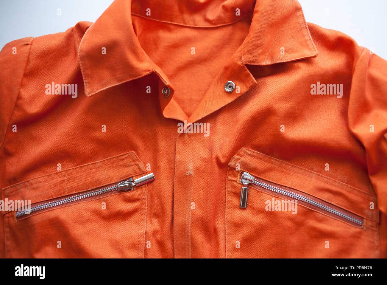 An orange jumpsuit of a prisoner. close up. Prison clothes, prisoner overalls Stock Photo