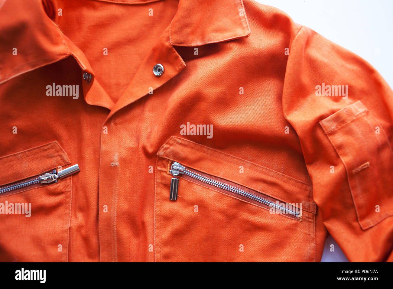 An orange jumpsuit of a prisoner. close up. Prison clothes, jumpsuit sentenced to correctional labor, criminal penalties Stock Photo
