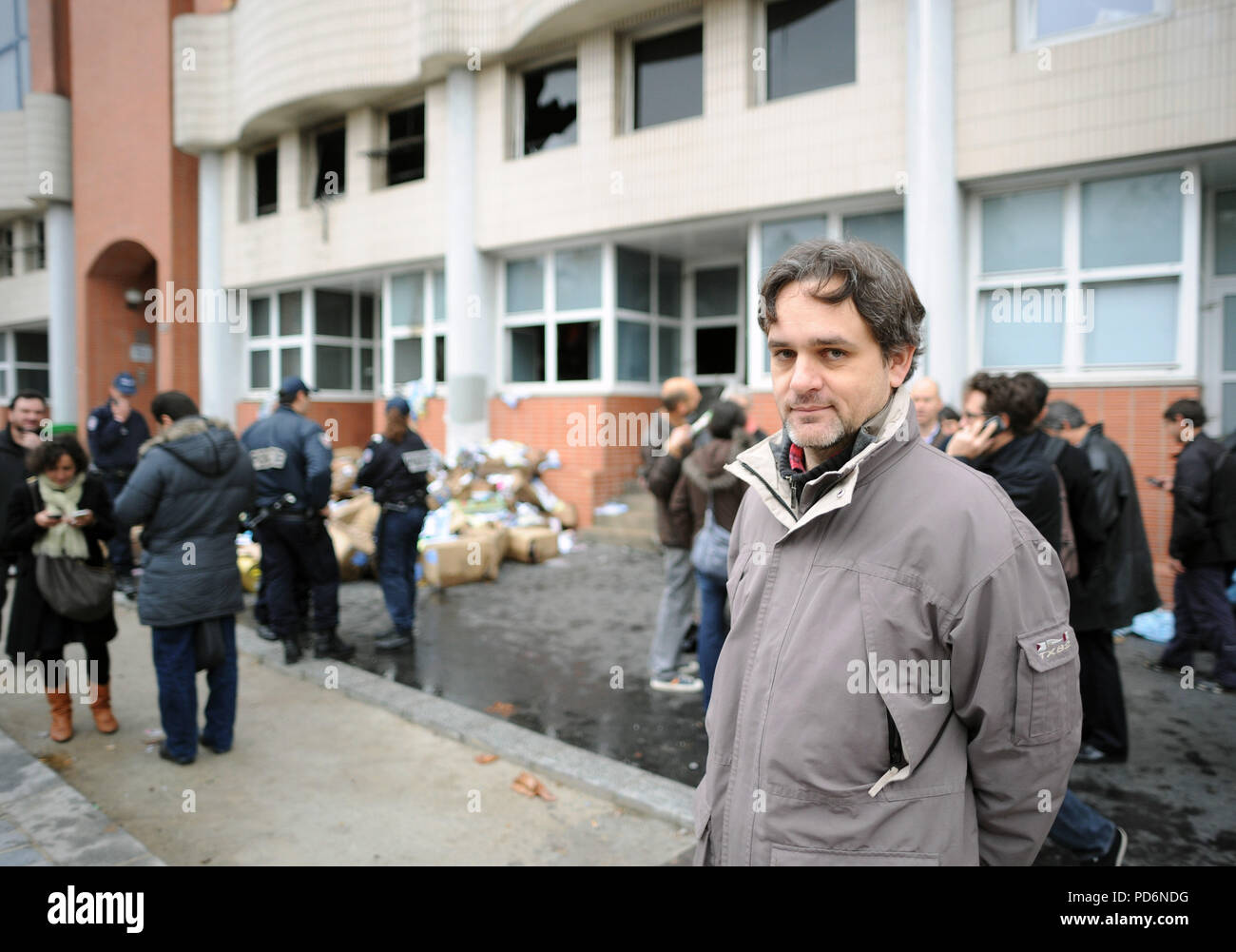 November 2, 2011 - Paris, France: One of the star cartoonist of Charlie Hebdo, Laurent Sourisseau, known as 'Riss',  stands in front of the gutted office of French satirical weekly paper Charlie Hebdo after an overnight petrol bomb attack. The paper was targeted after publishing a caricature of prophet Muhammad on its front cover for a special issue entitled 'Shariah Hebdo'.  Le dessinateur Laurent Sourisseau, dit Riss, devant les locaux de Charlie Hebdo apres qu'une attaque au cocktail molotov a declenche un incendie et detruit les locaux boulevard Davout de l'hebdomadaire satirique. Cette at Stock Photo