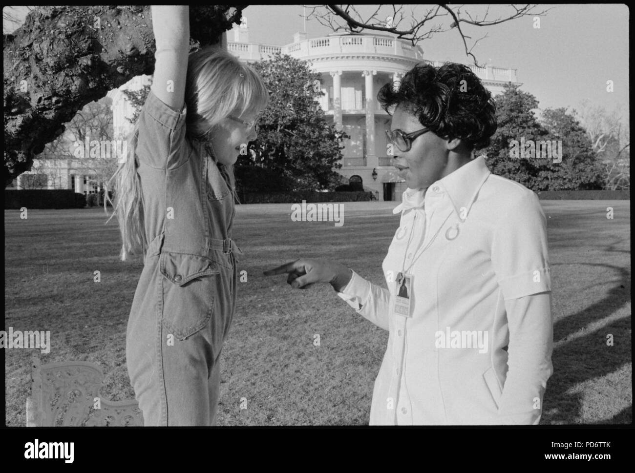 Amy Carter playing on the White House grounds with Mary Fitzpatrick. - Stock Photo