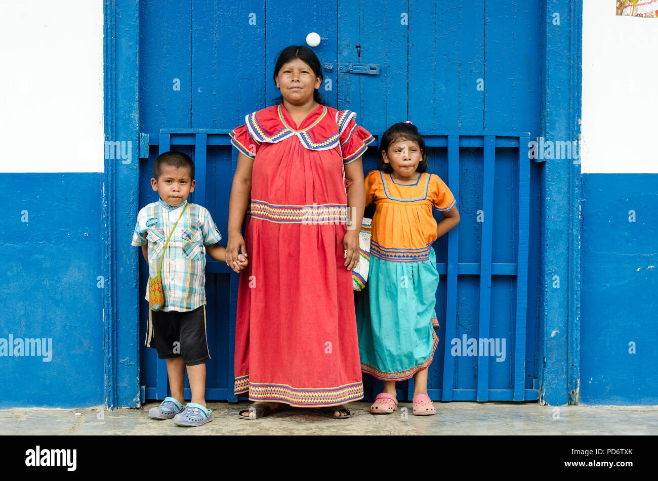 A ngobe woman dressing the traditional costumes and its children. Stock Photo