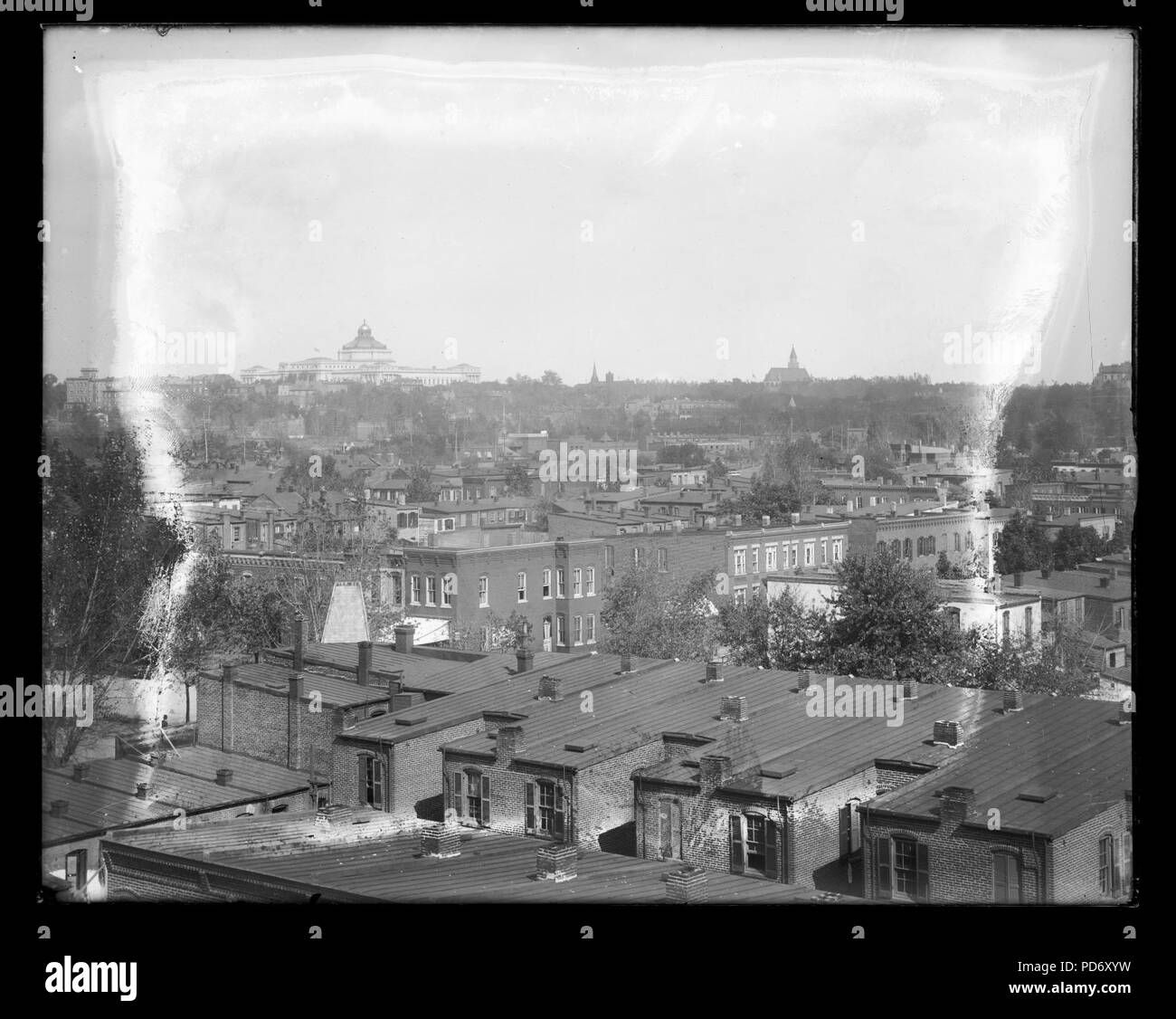 An elevated view of roof tops of row houses and other buildings ...