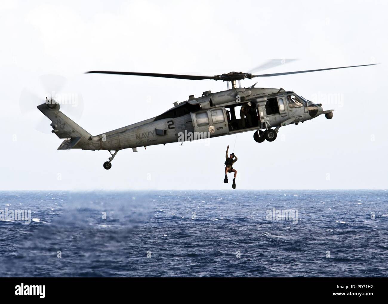 An MH-60S Sea Hawk helicopter from the Eightballers of Helicopter Sea Combat Squadron (HSC) 8 demonstrates how search and rescue sailors operate Stock Photo