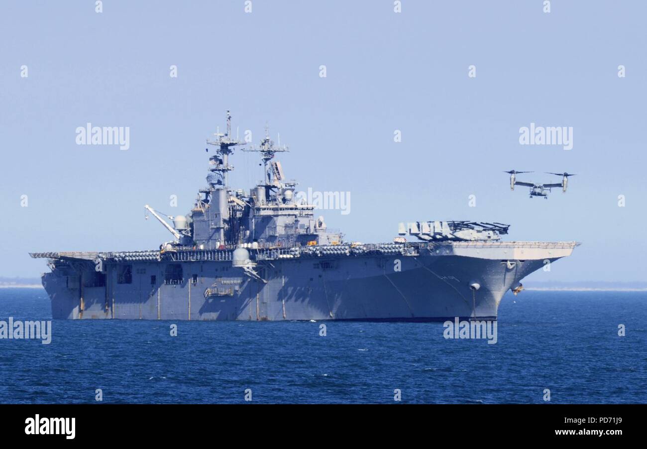 An MV-22 Osprey prepares to land on the flight deck of the amphibious assault ship USS Wasp. (6811741387). Stock Photo