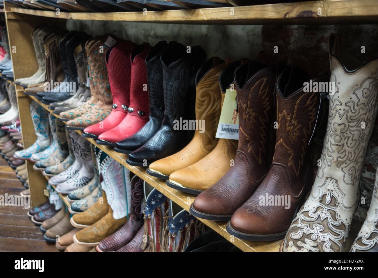 Rows of cowboy boots for sale in a boot shop in Nashville, TN, USA Stock Photo