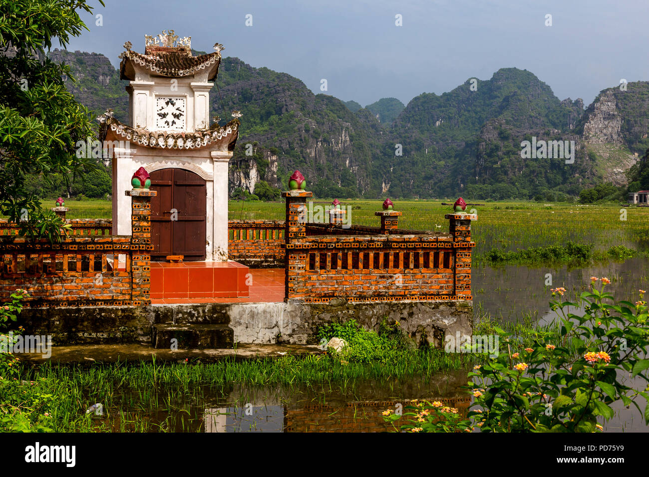 Pagoda in the field in Vietnam Ninh Binh Porvence. Mountians and rice fields are in the background. Stock Photo