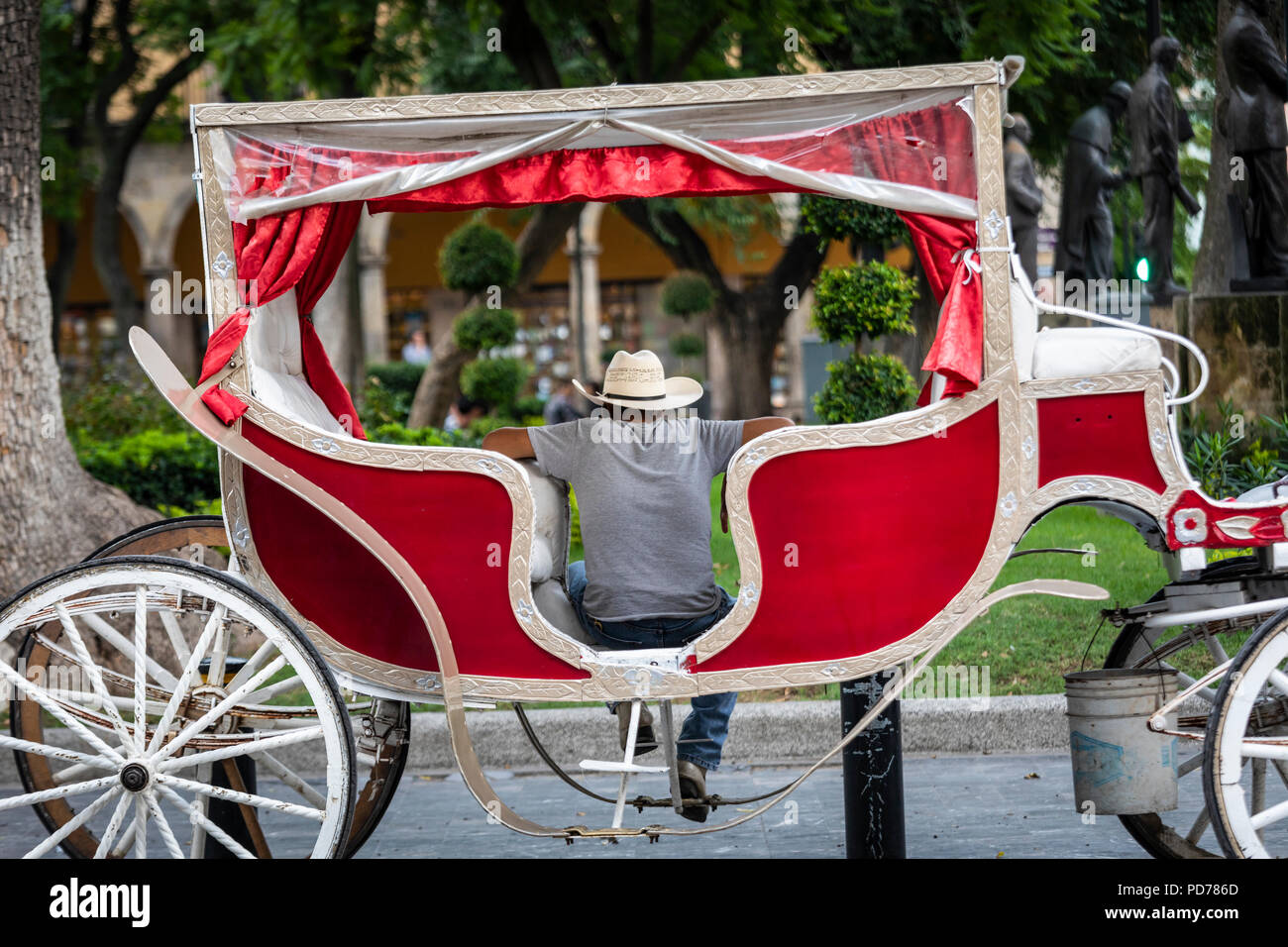 A horse drawn carriage driver waits for customers in downtown Guadalajara, Mexico. Stock Photo