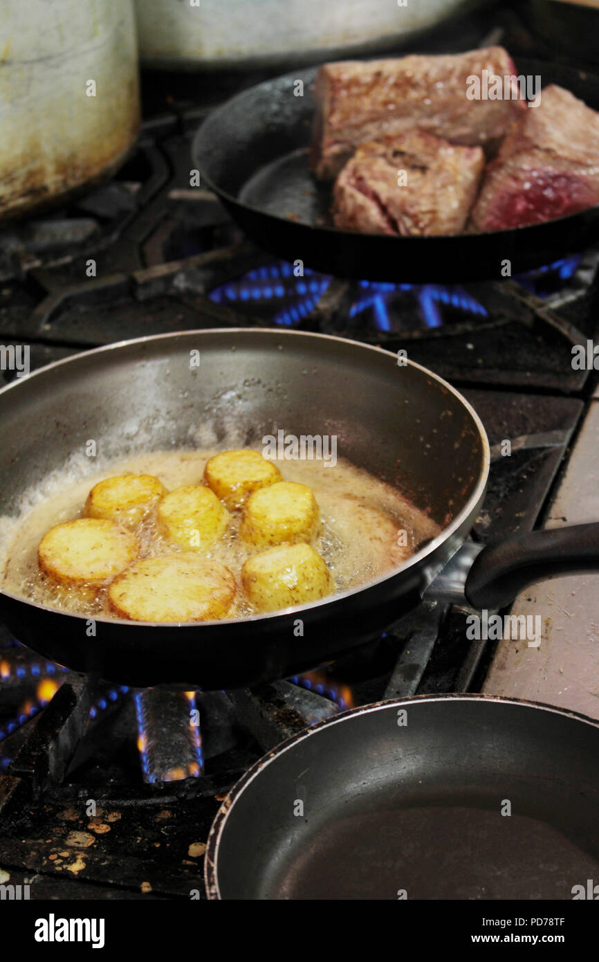 cooking meat on stove Stock Photo Alamy