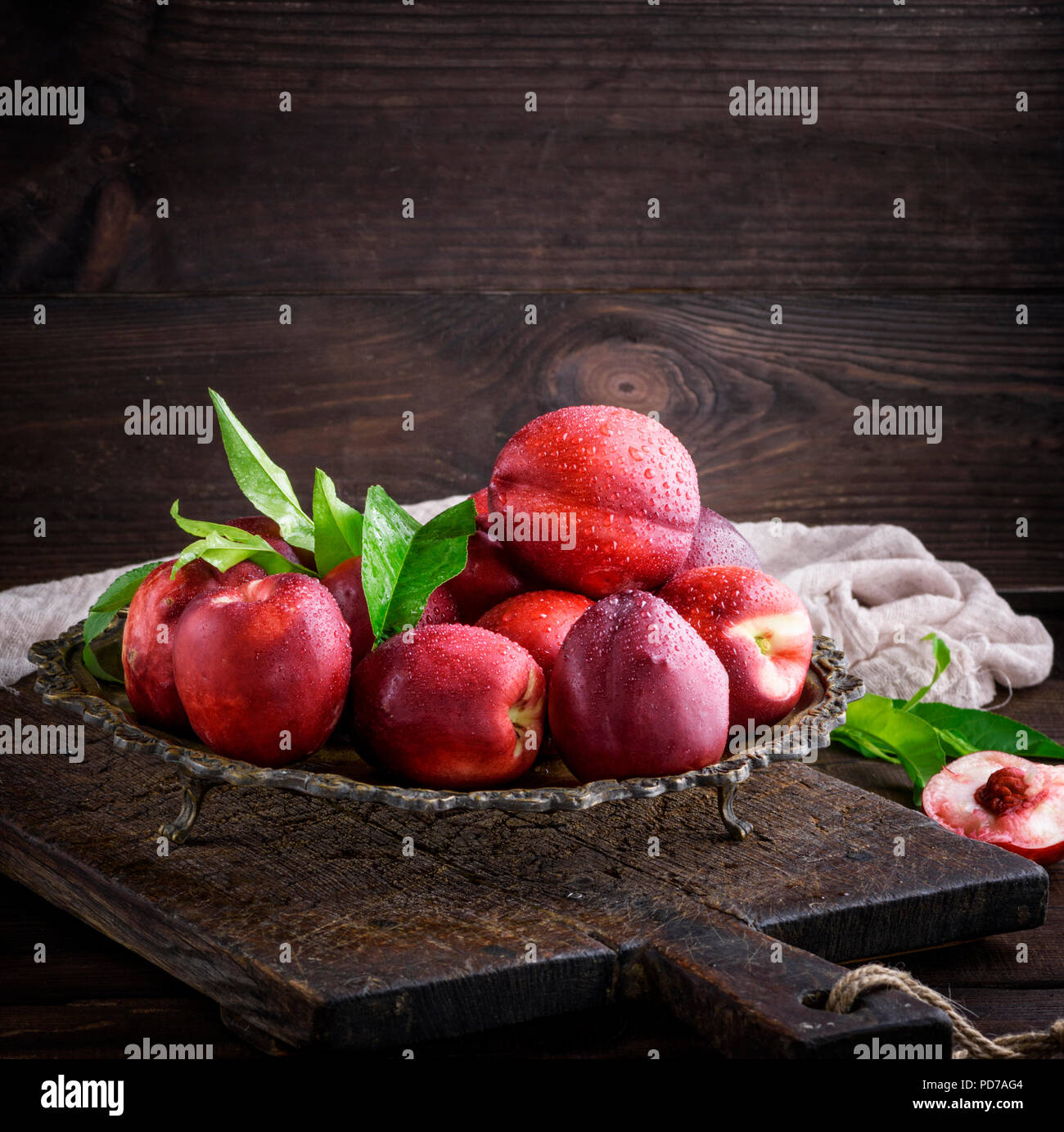 red ripe peaches nectarine in an iron plate,  close up Stock Photo