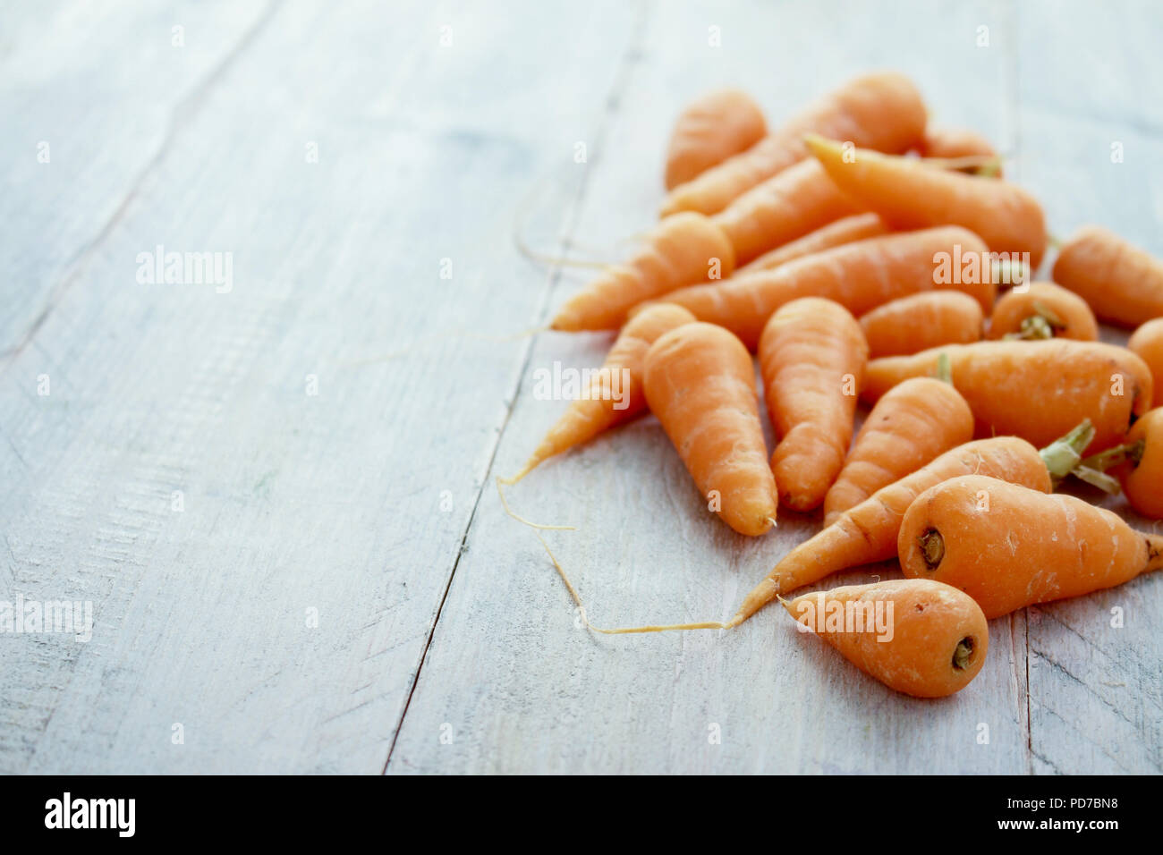 preparing small baby carrots Stock Photo