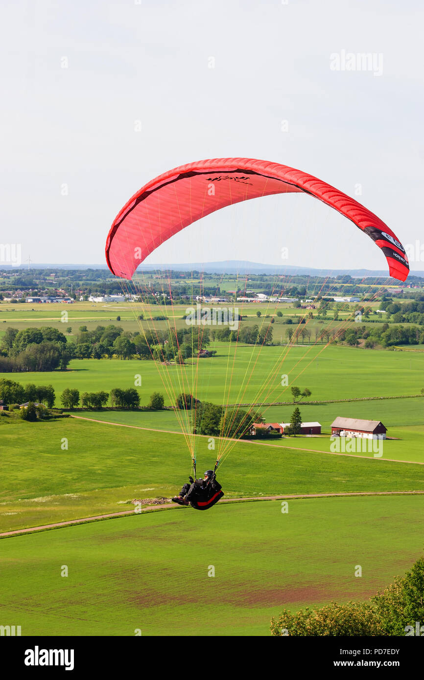 Paragliders flying over a rural landscape Stock Photo
