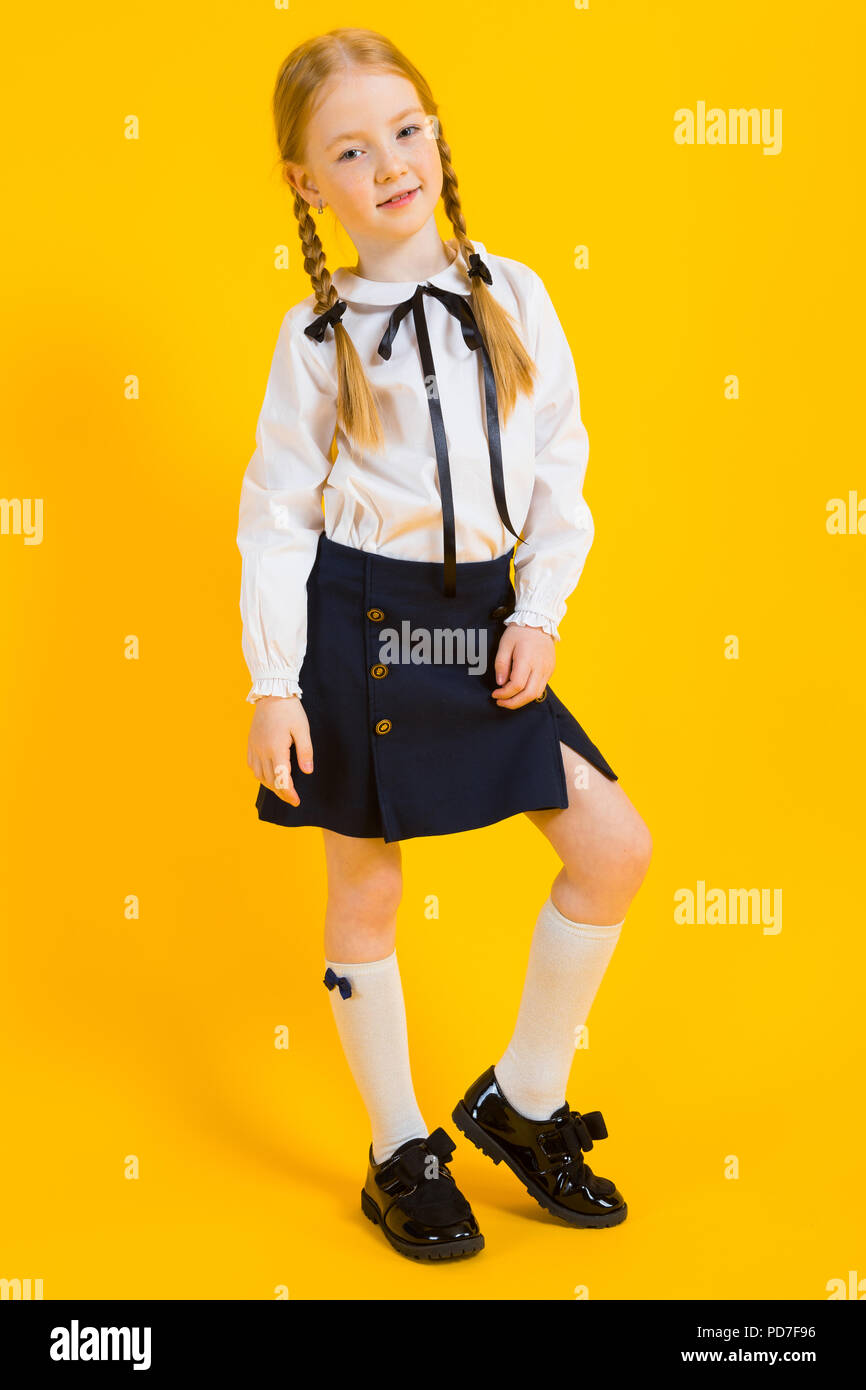 girl-with-red-pigtails-on-a-yellow-background-a-beautiful-girl-is