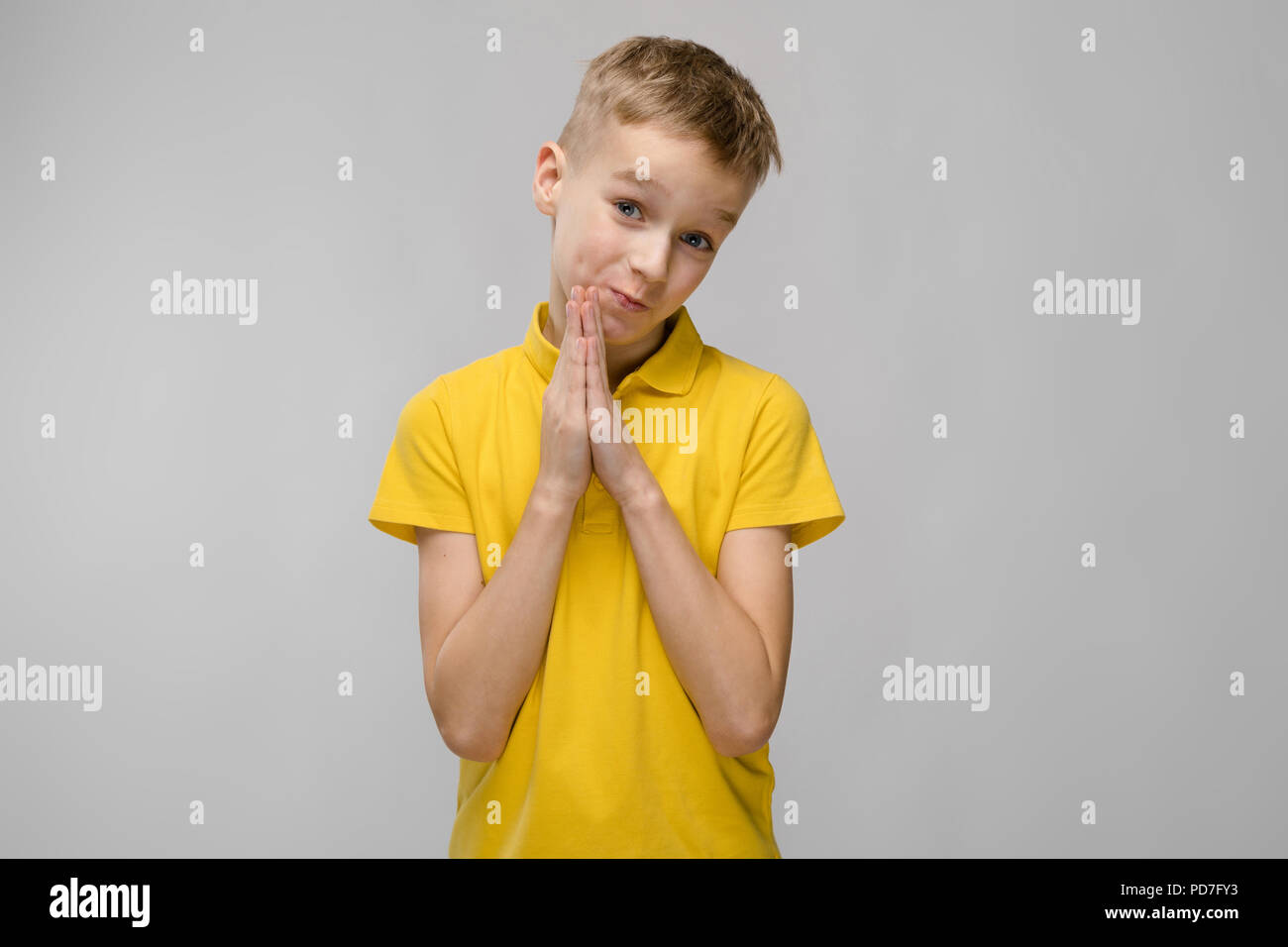 Portrait of cute little blonde caucasian boy in yellow t-shirt hoping ...