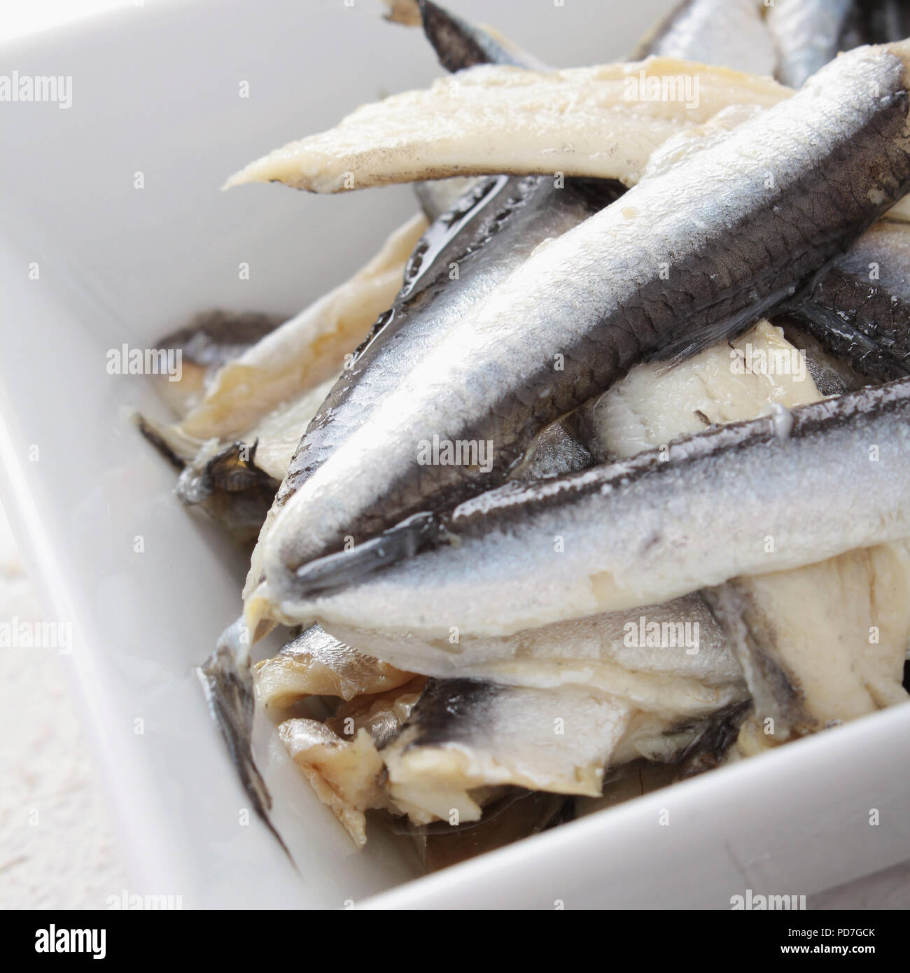 cured anchovies in dish Stock Photo Alamy
