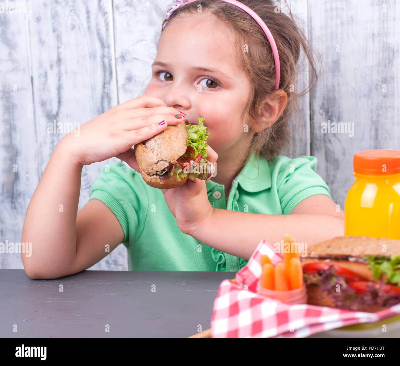 A little girl is eating her lunch at school. Lunch schoolgirl. Toast