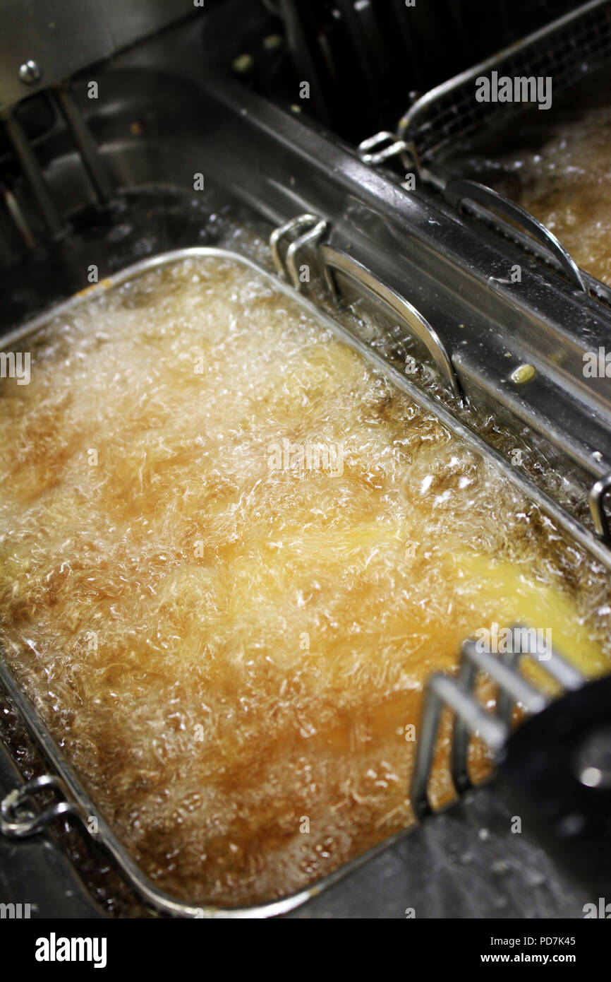 frying chipped potatoes in deep fat fryer Stock Photo Alamy