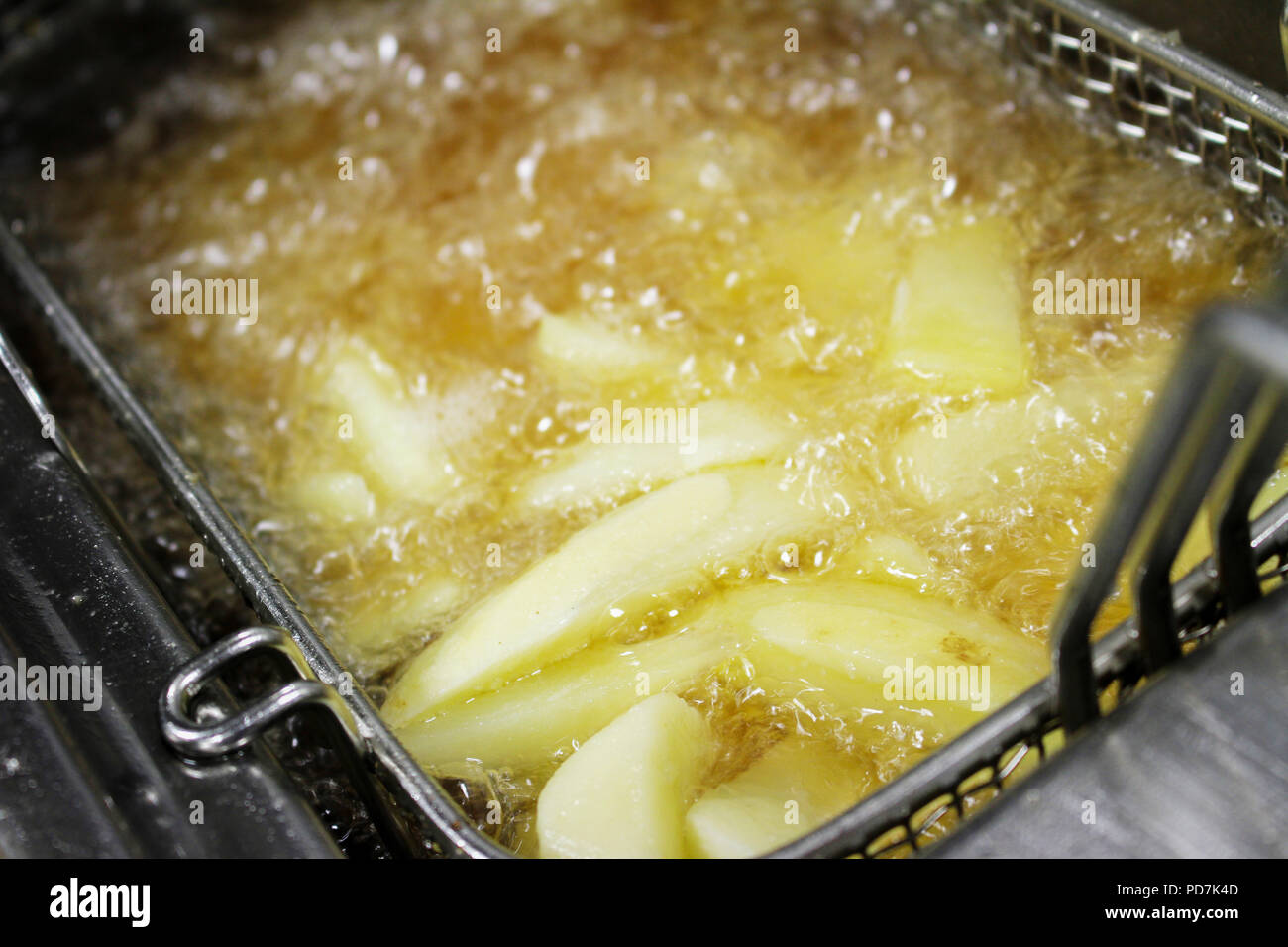frying chipped potatoes in deep fat fryer Stock Photo Alamy